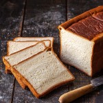 Brioche Tin Loaf Unsliced, Frozen - The Artisan Bakery loose unpackaged loaf on white background